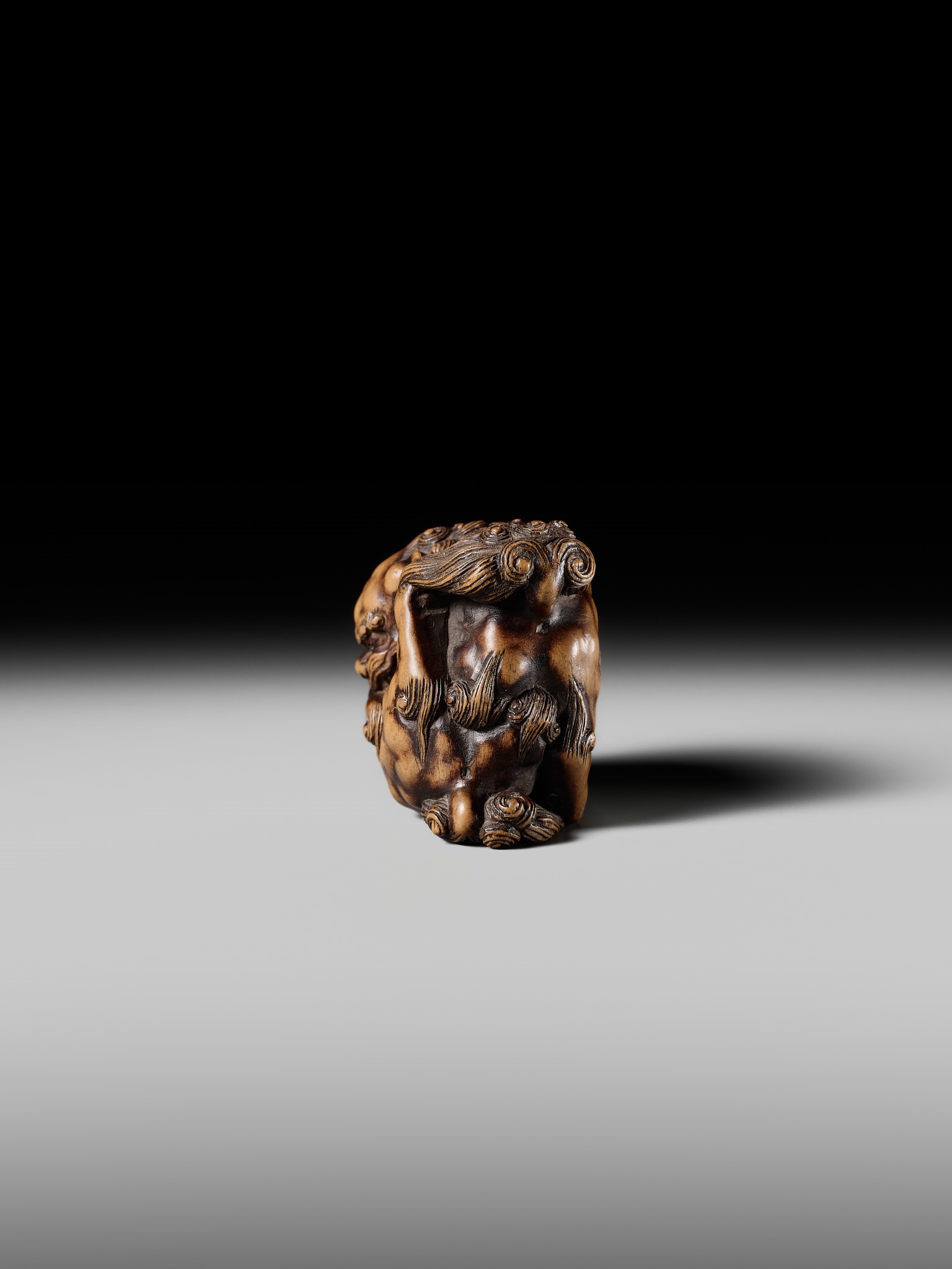 Artwork by Tomoyuki Tanaka, A LARGE AND POWERFUL WOOD NETSUKE OF TWO SHISHI, Made of Wood