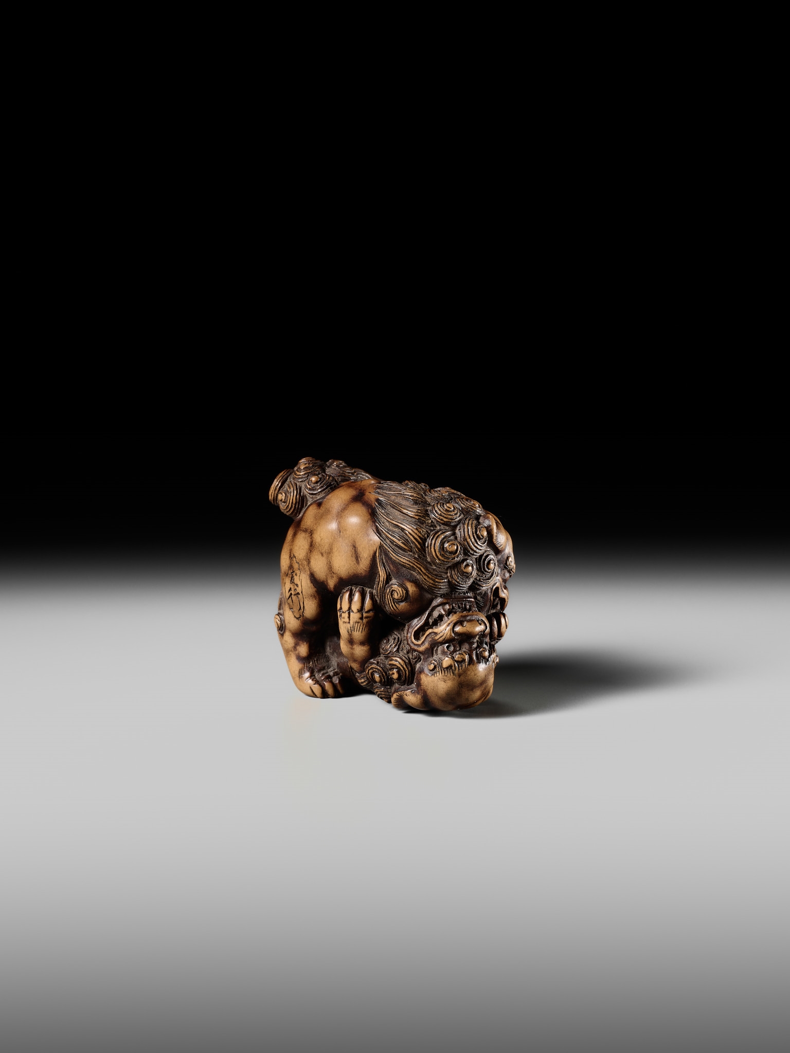 Artwork by Tomoyuki Tanaka, A LARGE AND POWERFUL WOOD NETSUKE OF TWO SHISHI, Made of Wood
