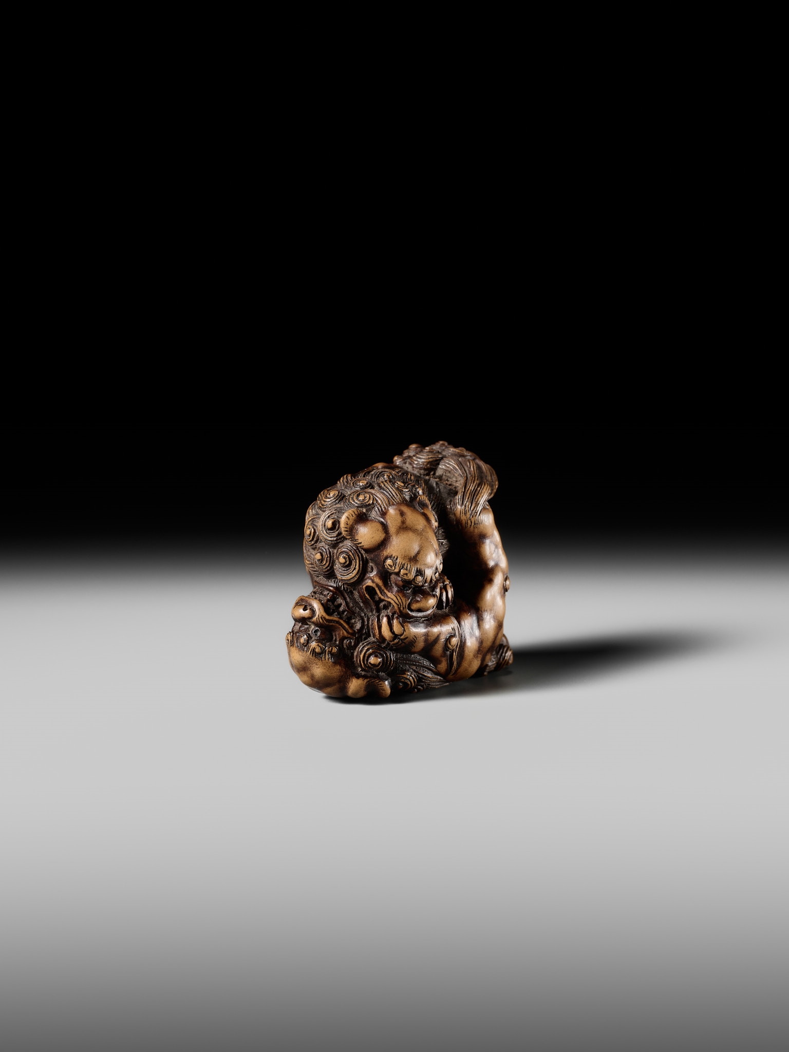 Artwork by Tomoyuki Tanaka, A LARGE AND POWERFUL WOOD NETSUKE OF TWO SHISHI, Made of Wood