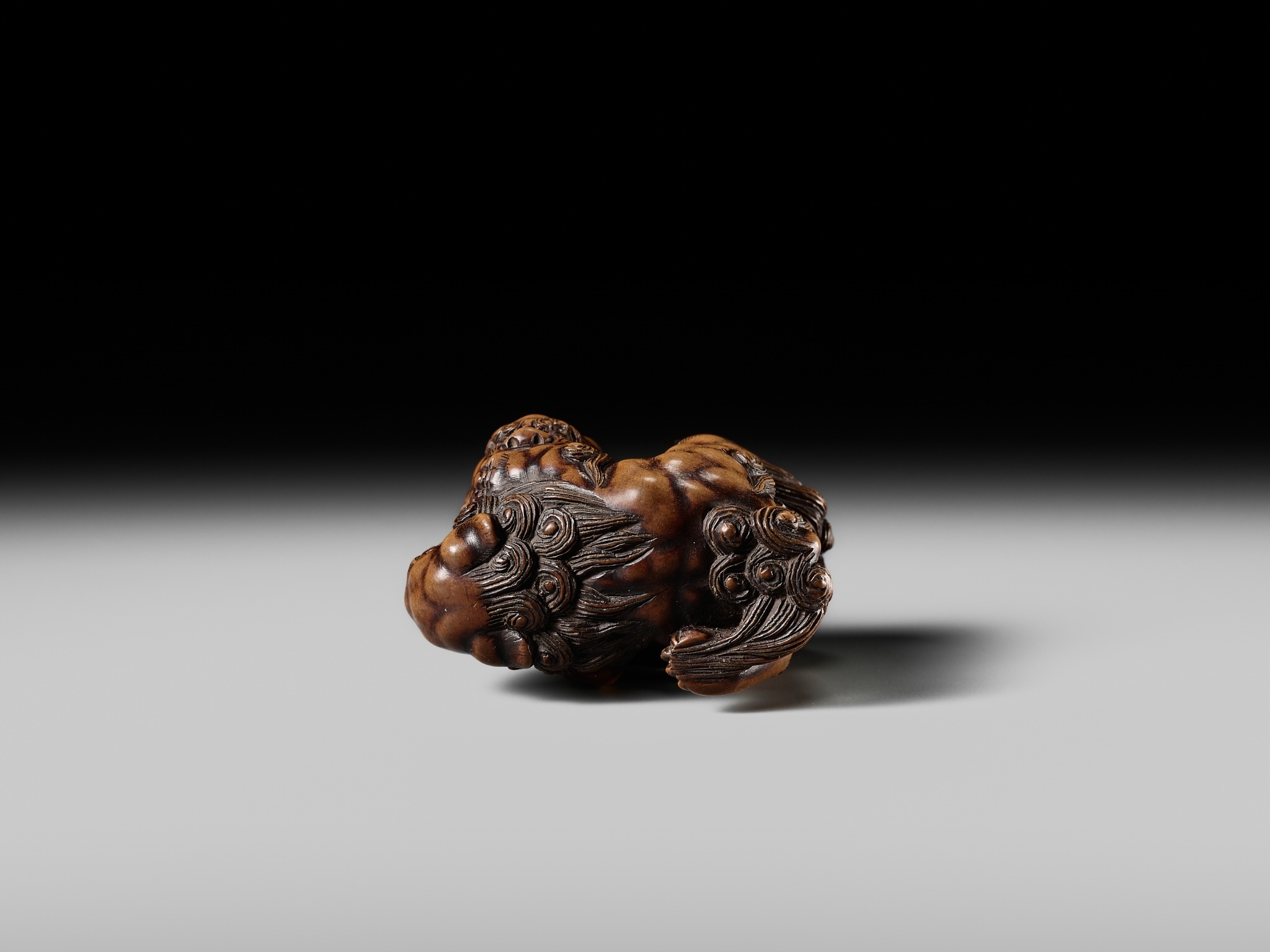 Artwork by Tomoyuki Tanaka, A LARGE AND POWERFUL WOOD NETSUKE OF TWO SHISHI, Made of Wood