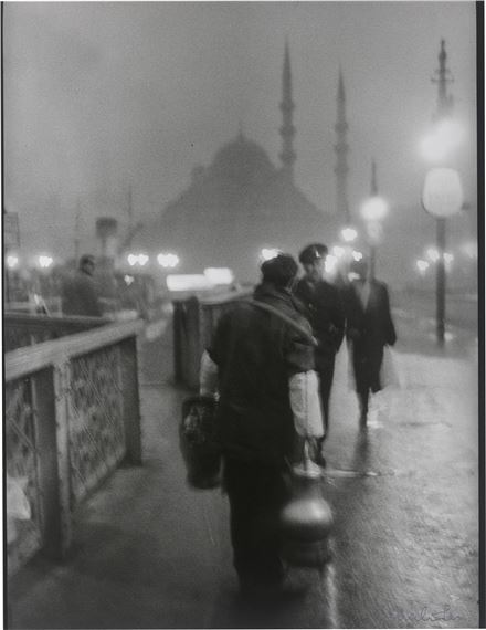 Salep' Seller in early morning light on the old Galata Bridge - Ara Güler