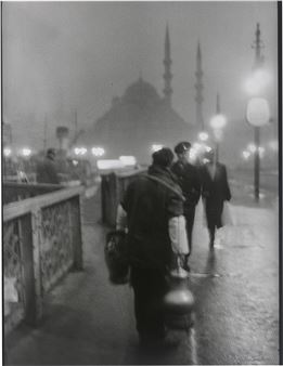 Salep' Seller in early morning light on the old Galata Bridge - Ara Güler