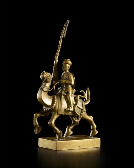 A cast brass model of a mounted soldier : a musket man on his camel