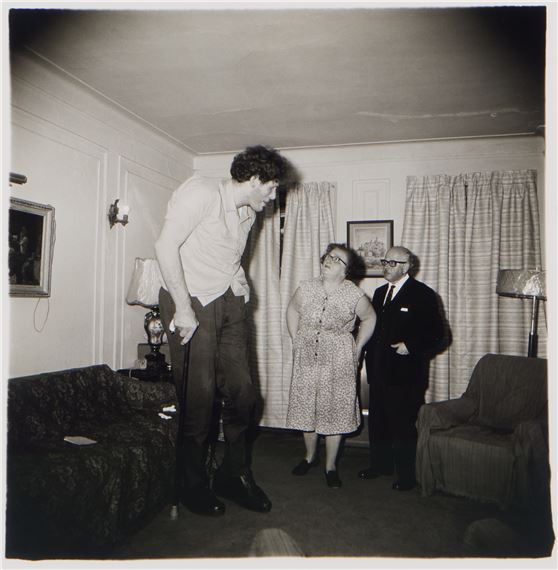 A Jewish giant at home with his parents in the Bronx, N. Y