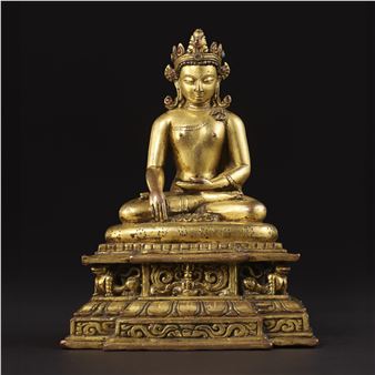 A GILT COPPER ALLOY FIGURE OF SHAKYAMUNI BUDDHA - Nepalese School, 13th Century