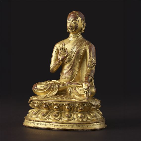 A GILT COPPER FIGURE OF DROKMI LOTSAWA SHAKYA YESHE by Tibetan School, 15th Century
