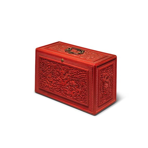 A RARE CARVED CINNABAR LACQUER 'NINE DRAGONS' PORTABLE CABINET AND COVER