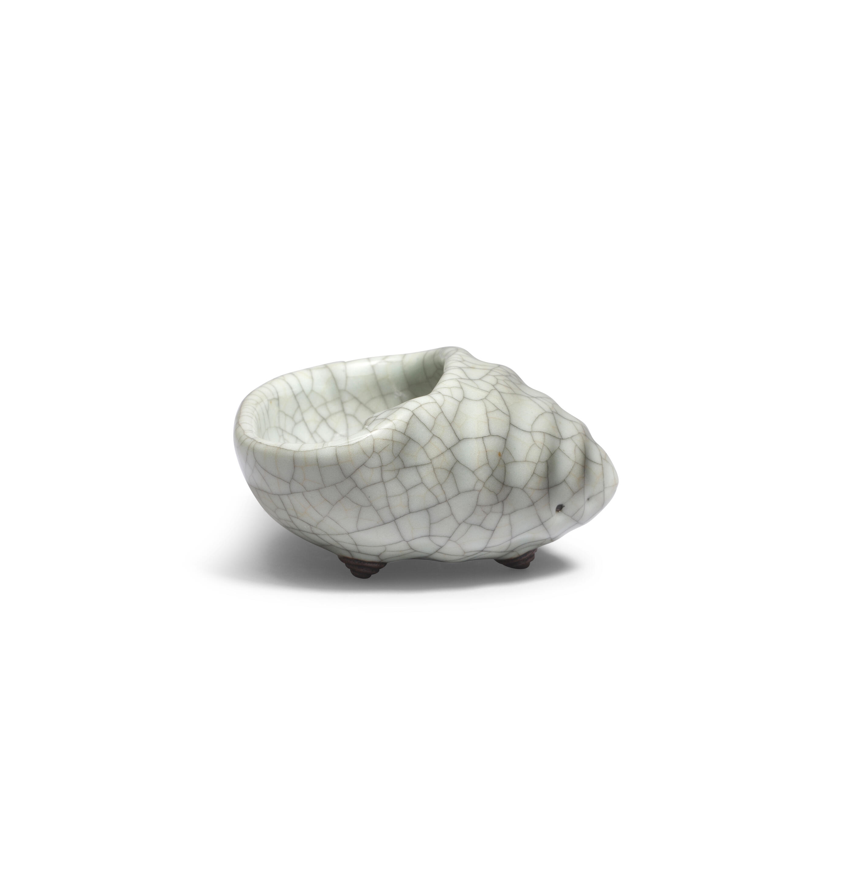 Artwork by Chinese School, A rare Ge-Type Tripod Conch-shaped Waterpot, Made of Naturalistically moulded in the form of a tapering shell with a large oval mouth, covered in a greyish sea-green glaze with fine grey craquelure save the three feet in the form of smaller swirling conches, glazed mother-of-pearl washer