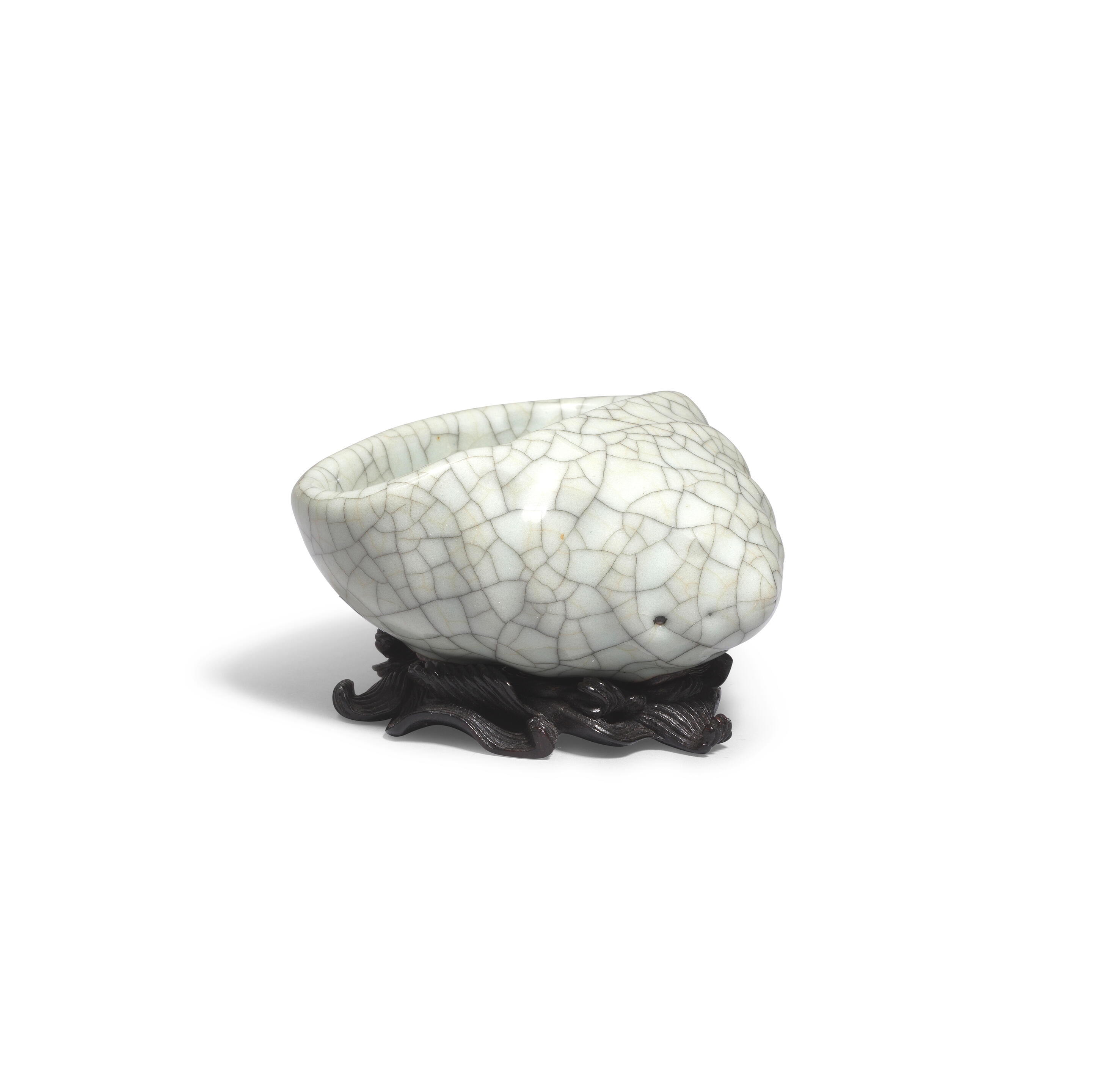 Artwork by Chinese School, A rare Ge-Type Tripod Conch-shaped Waterpot, Made of Naturalistically moulded in the form of a tapering shell with a large oval mouth, covered in a greyish sea-green glaze with fine grey craquelure save the three feet in the form of smaller swirling conches, glazed mother-of-pearl washer