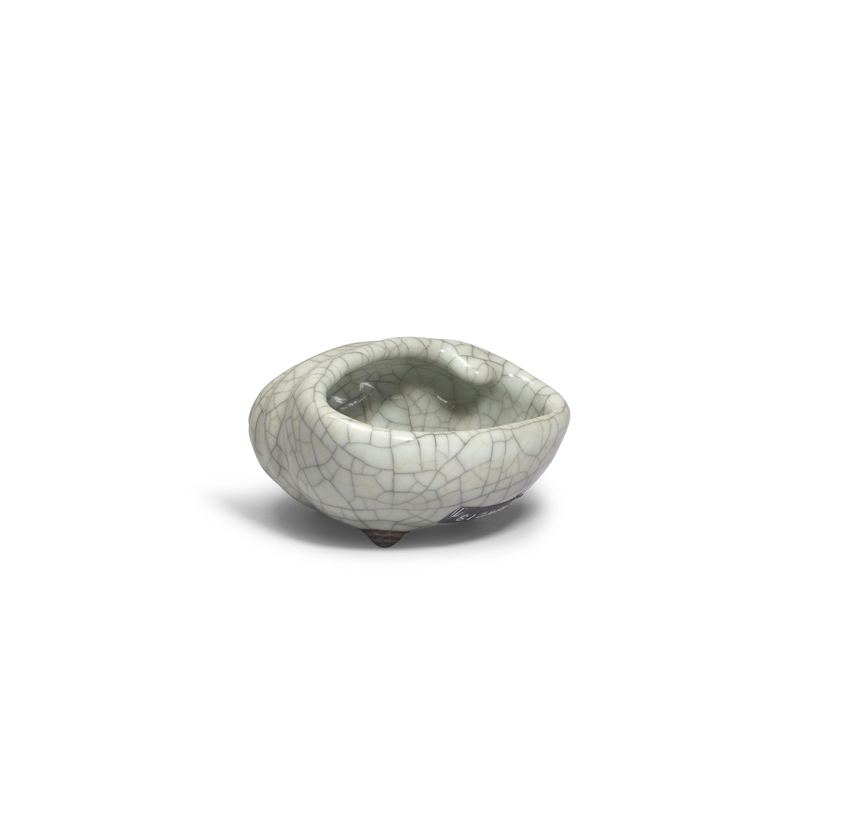 Artwork by Chinese School, A rare Ge-Type Tripod Conch-shaped Waterpot, Made of Naturalistically moulded in the form of a tapering shell with a large oval mouth, covered in a greyish sea-green glaze with fine grey craquelure save the three feet in the form of smaller swirling conches, glazed mother-of-pearl washer