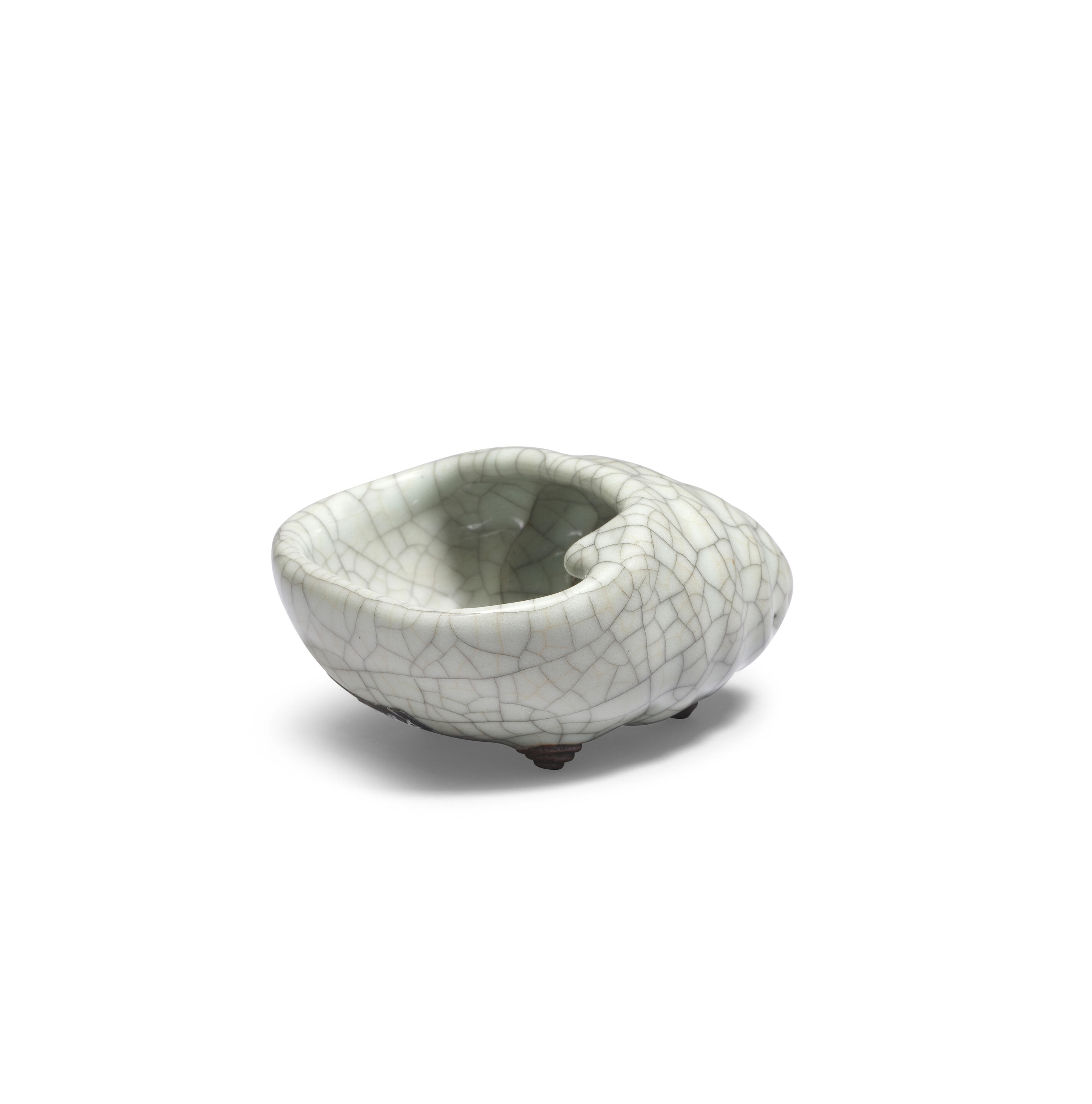Artwork by Chinese School, A rare Ge-Type Tripod Conch-shaped Waterpot, Made of Naturalistically moulded in the form of a tapering shell with a large oval mouth, covered in a greyish sea-green glaze with fine grey craquelure save the three feet in the form of smaller swirling conches, glazed mother-of-pearl washer