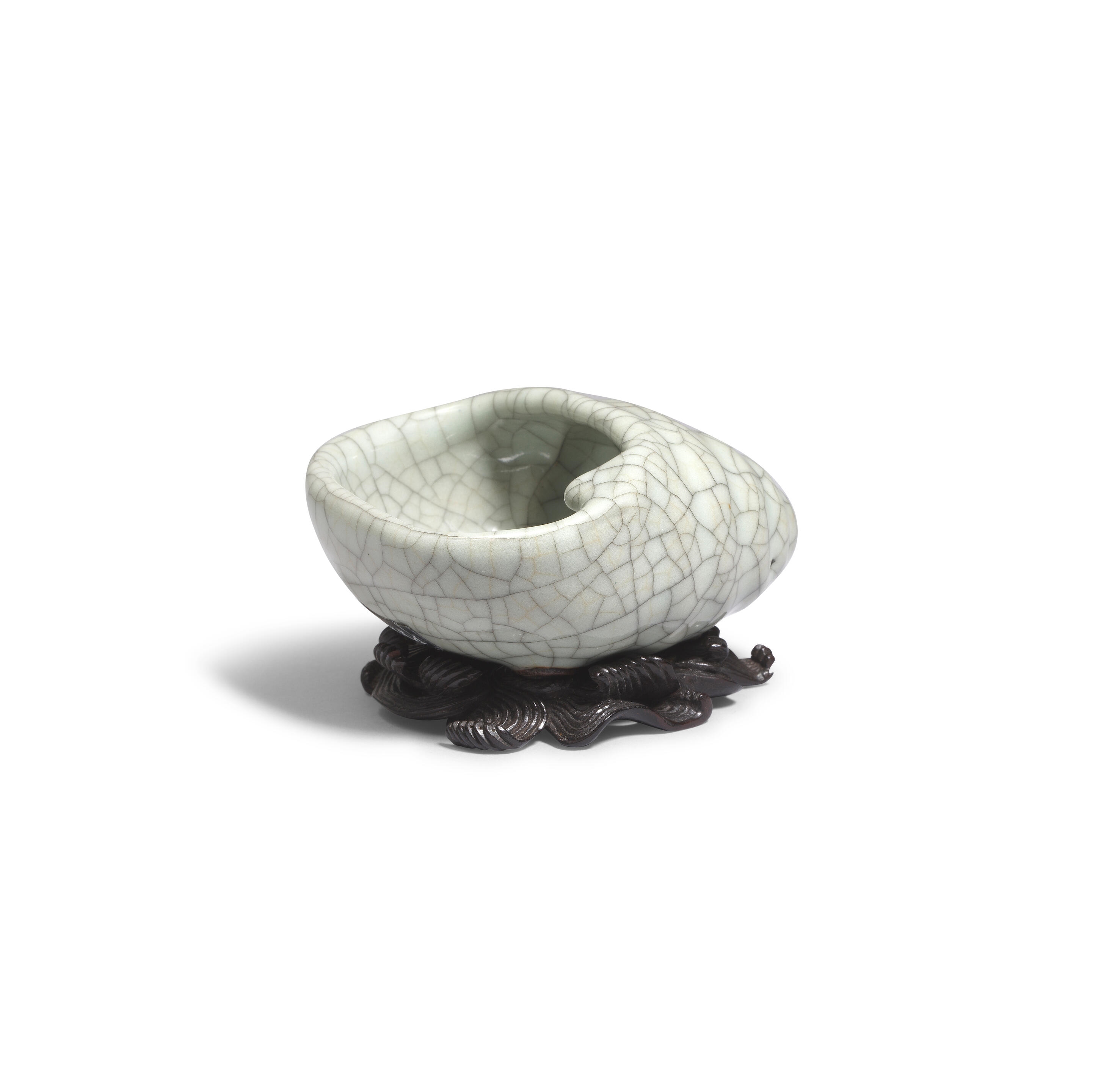 Artwork by Chinese School, A rare Ge-Type Tripod Conch-shaped Waterpot, Made of Naturalistically moulded in the form of a tapering shell with a large oval mouth, covered in a greyish sea-green glaze with fine grey craquelure save the three feet in the form of smaller swirling conches, glazed mother-of-pearl washer
