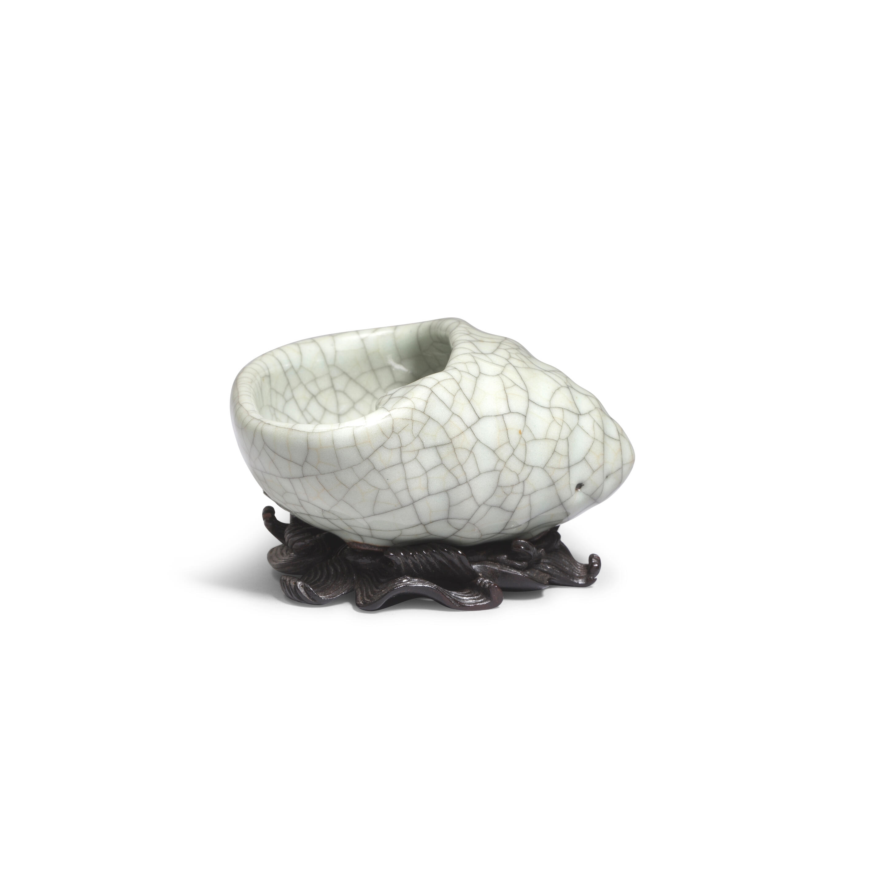 Artwork by Chinese School, A rare Ge-Type Tripod Conch-shaped Waterpot, Made of Naturalistically moulded in the form of a tapering shell with a large oval mouth, covered in a greyish sea-green glaze with fine grey craquelure save the three feet in the form of smaller swirling conches, glazed mother-of-pearl washer