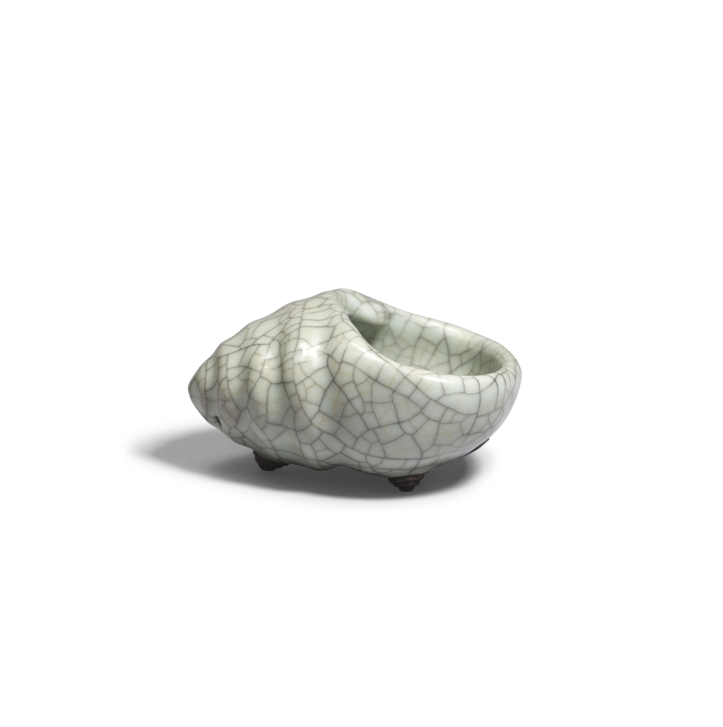 Artwork by Chinese School, A rare Ge-Type Tripod Conch-shaped Waterpot, Made of Naturalistically moulded in the form of a tapering shell with a large oval mouth, covered in a greyish sea-green glaze with fine grey craquelure save the three feet in the form of smaller swirling conches, glazed mother-of-pearl washer