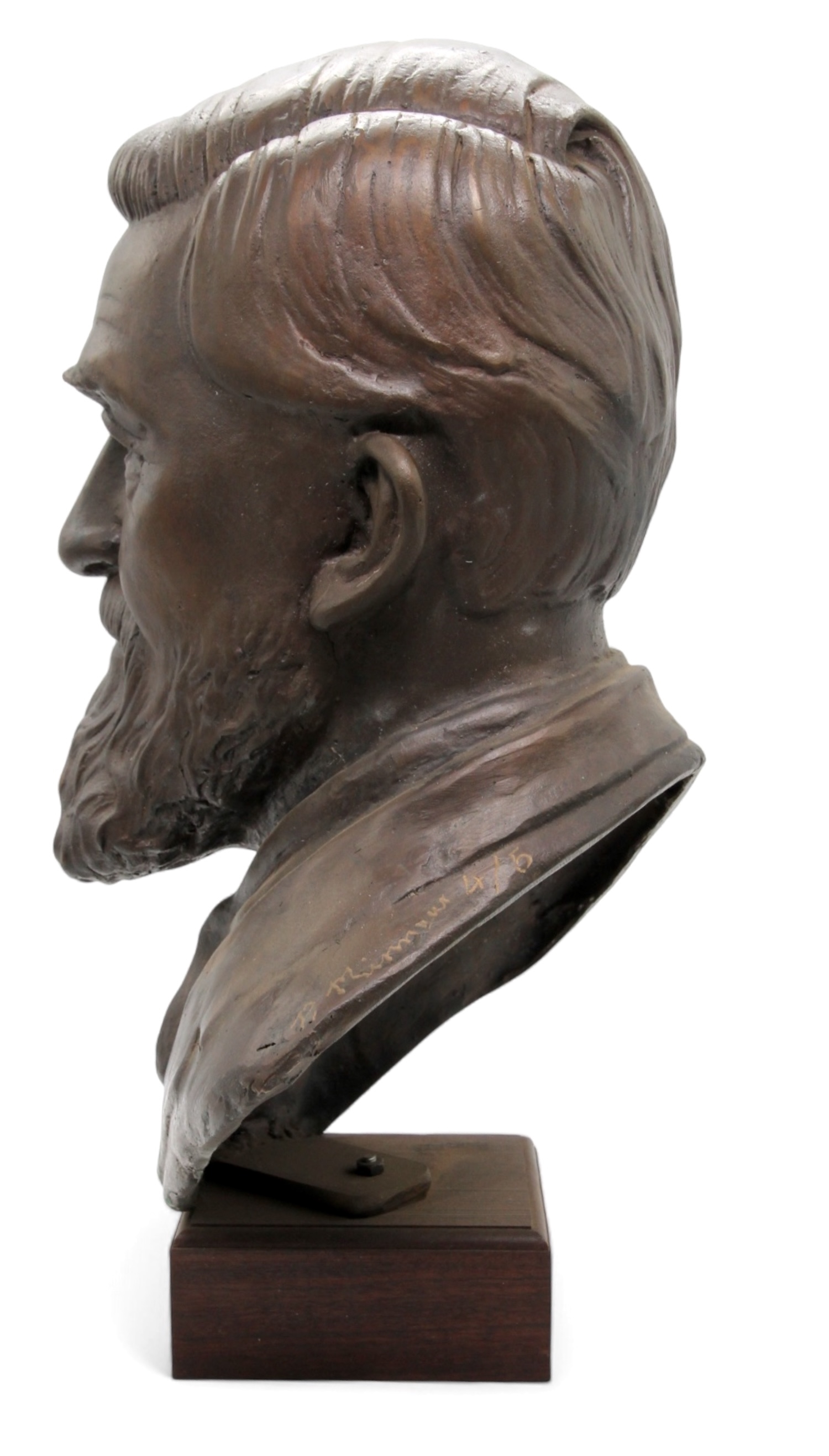 A bronze bust of a bearded man with a solemn expression, mounted on a dark rectangular base.