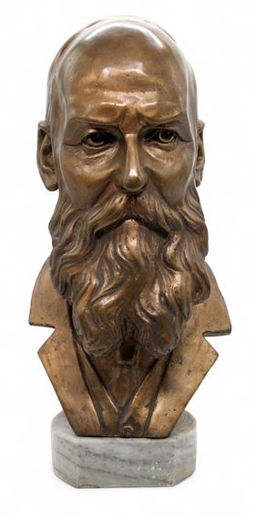 A bronze bust of a bearded figure with a marble base.