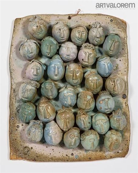 Blue enameled stoneware plaque with applique faces by Bernard Courcoule