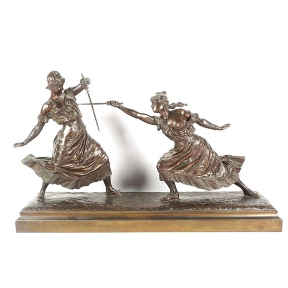 A dynamic bronze sculpture of two figures engaged in a sword duel.