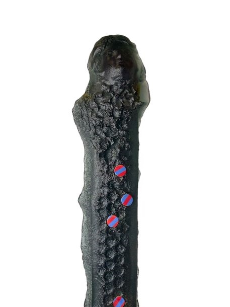 A dark, textured staff-like object with a purple bell at the base.