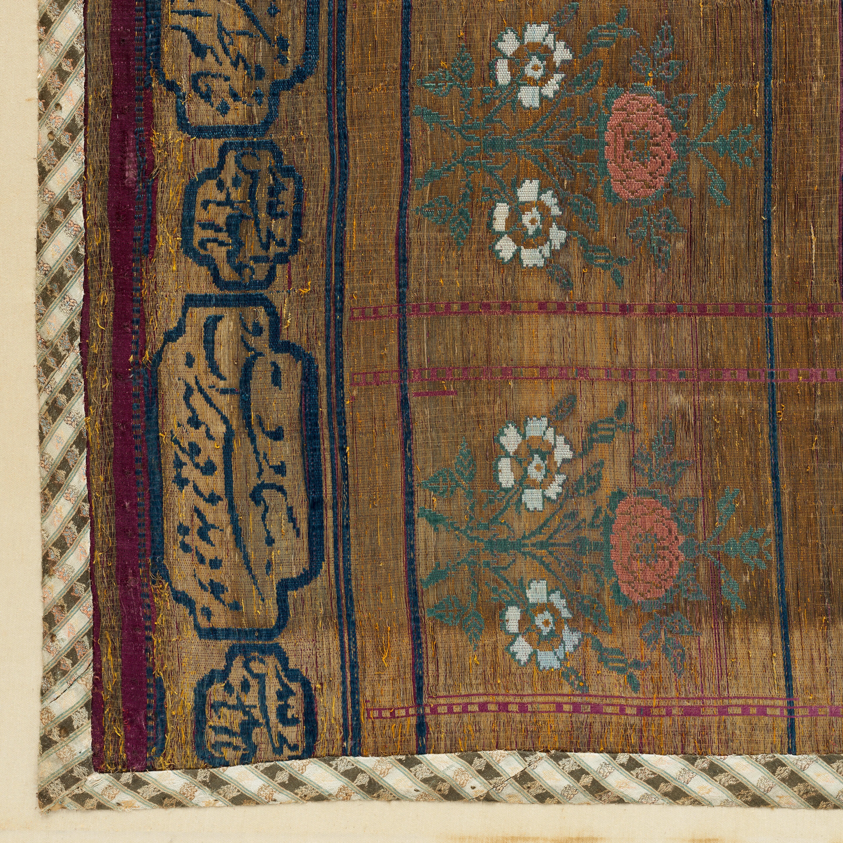 Artwork by Persian School, 19th Century, An impressive Qajar for Ashura day celebrations, Made of Rectangular form, woven and embroidered in polychrome silk and metal thread with the Imam Husayn mounted on horseback carrying a shield and lance, the head and upper body of a child behind him, spandrels above, the border with a repeat design of floral sprays, above and below bands of inscription-filled cartouches, woven silk edging