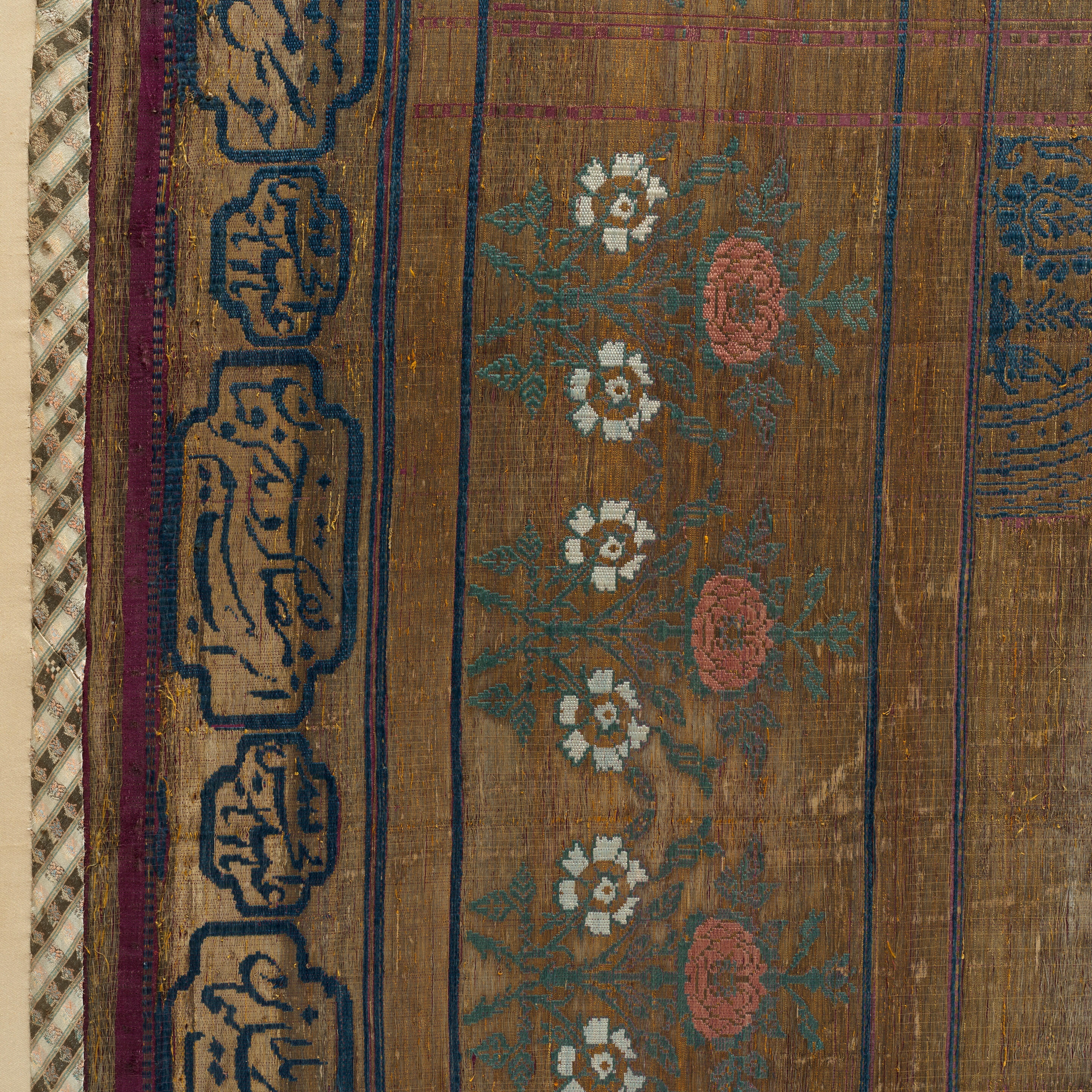 Artwork by Persian School, 19th Century, An impressive Qajar for Ashura day celebrations, Made of Rectangular form, woven and embroidered in polychrome silk and metal thread with the Imam Husayn mounted on horseback carrying a shield and lance, the head and upper body of a child behind him, spandrels above, the border with a repeat design of floral sprays, above and below bands of inscription-filled cartouches, woven silk edging