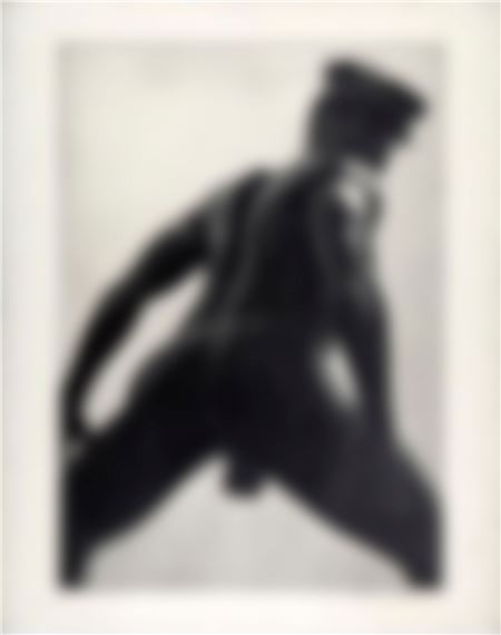 A blurry black-and-white image of a person in a dynamic pose.