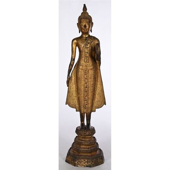 STATUE OF A STANDING BUDDHA in gilded and patinated bronze - Thai School, 19th Century