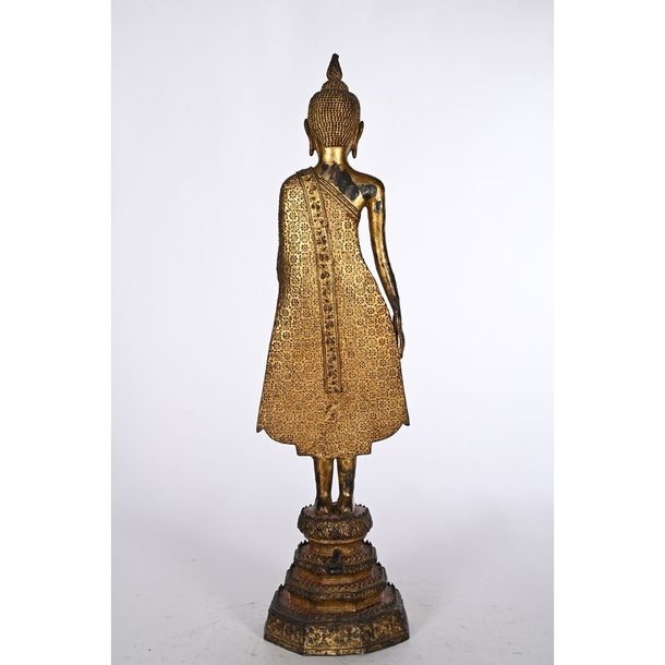 Artwork by Thai School, 19th Century, STATUE OF A STANDING BUDDHA in gilded and patinated bronze, Made of gilded and patinated bronze
