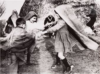 Children dancing with burlap sacks