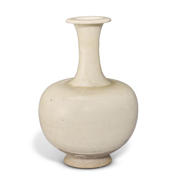 A WHITE-GLAZED BOTTLE VASE by Chinese School