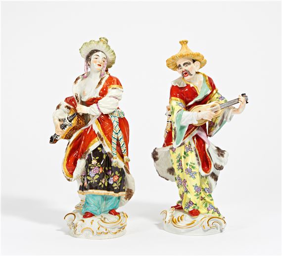 PORCELAIN FIGURINE OF A MALABAR MALE WITH A GUITAR AND FEMALE WITH A HURDY-GURDY