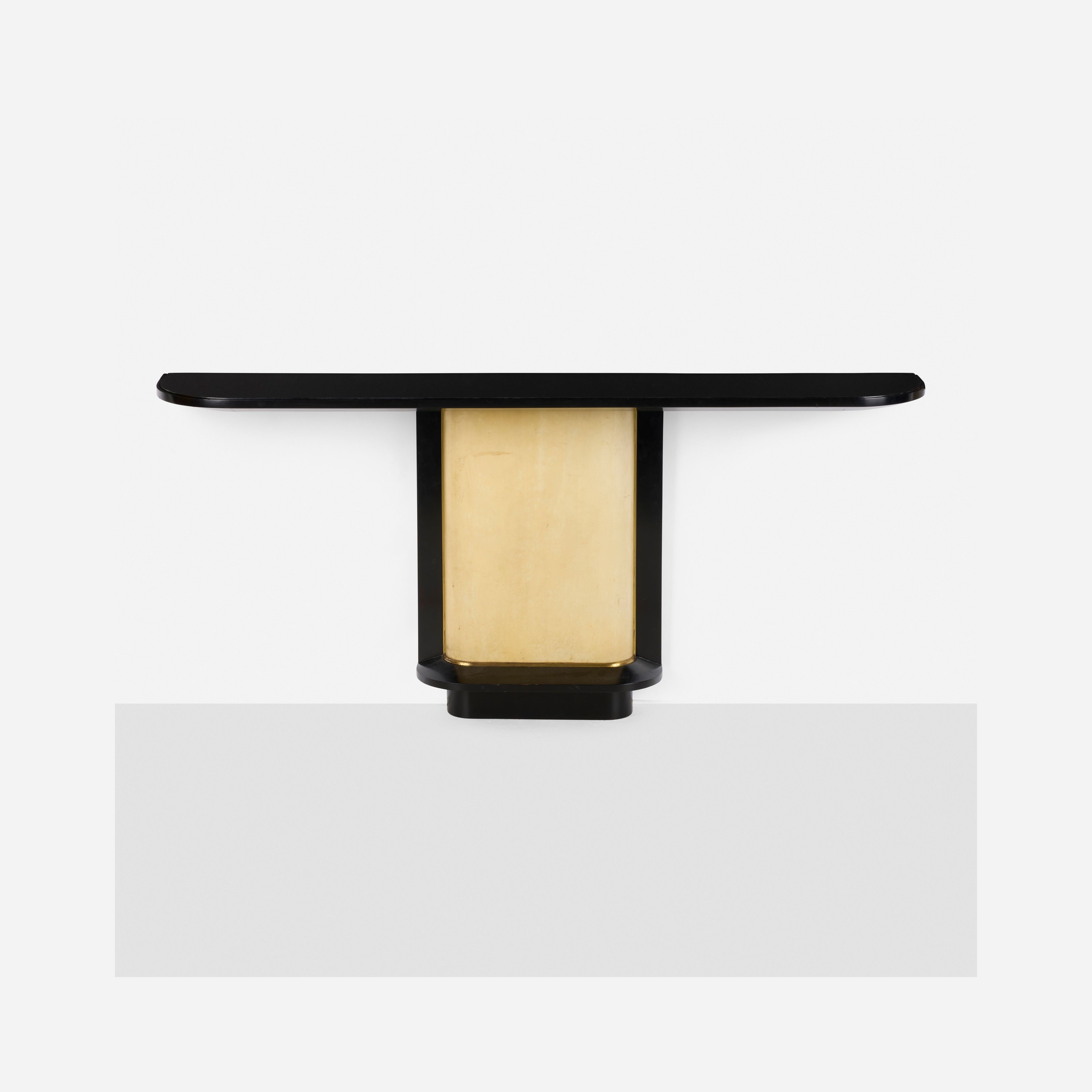 A minimalist wall sconce with a sleek black frame and a glowing gold center.