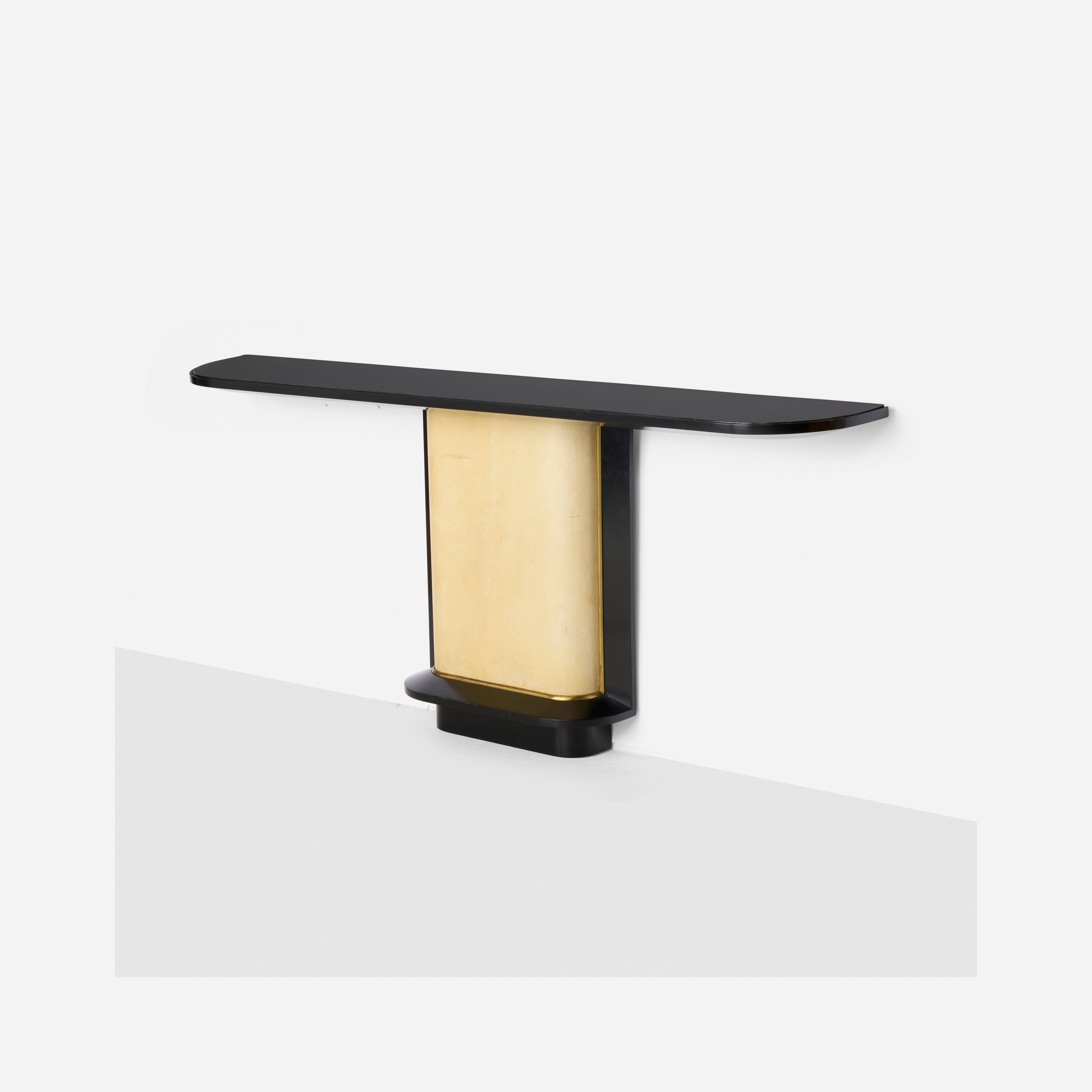 A minimalist wall sconce with a sleek black frame and a glowing gold center.