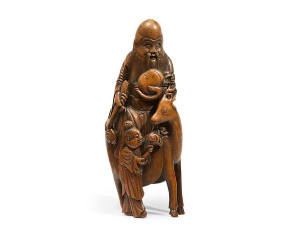 A Chinese bamboo carving of Shoulao and boy