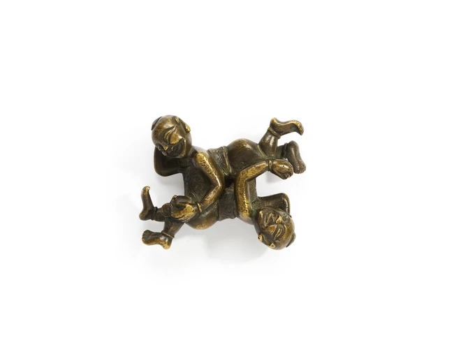 Artwork by Chinese School, A Chinese bronze 'puzzle group' paper weight, Made of Bronze