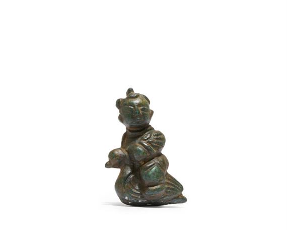 A miniature Chinese bronze figure of a boy riding a goose