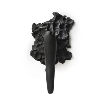 A minimalist black sculpture featuring a smooth handle emerging from a rough, cellular base.