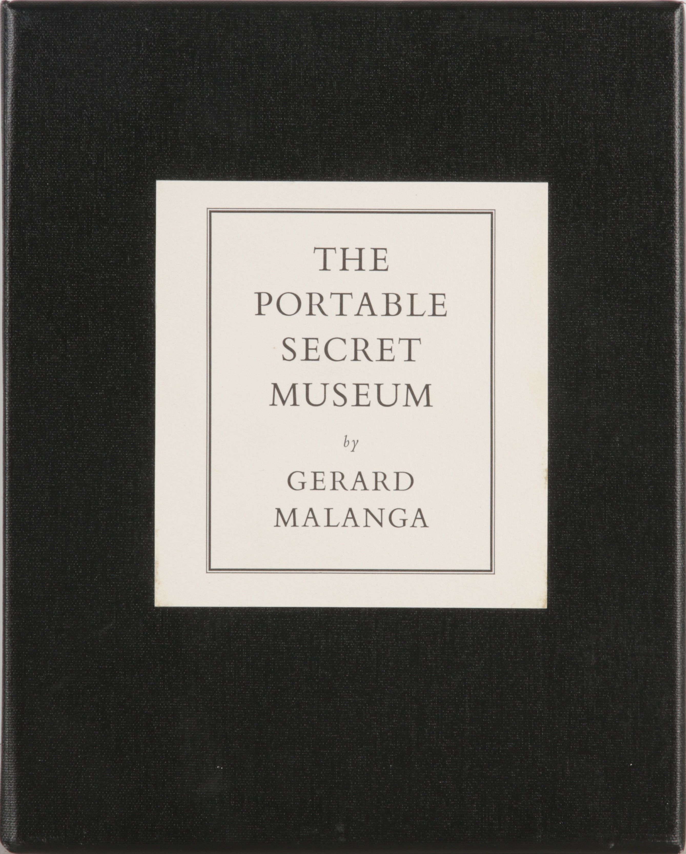 A minimalist book cover featuring a central white label with typographic text against a solid black background.
