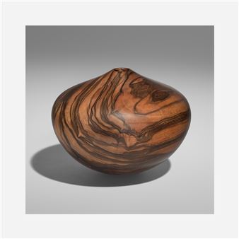 A wooden vase sitting on top of a table.