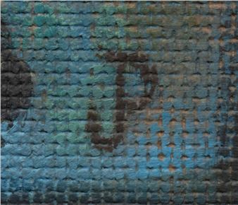 A weathered brick wall painted in shades of blue and green with a dark letter 'J' stenciled on it.