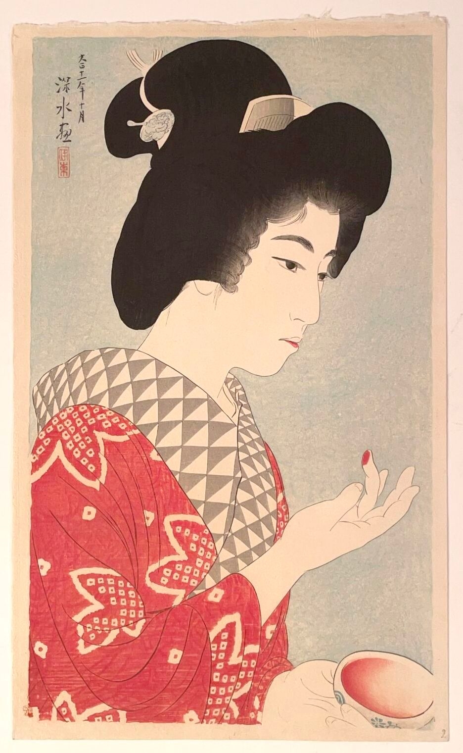 A profile portrait of a woman in traditional Japanese attire holding a small bowl.