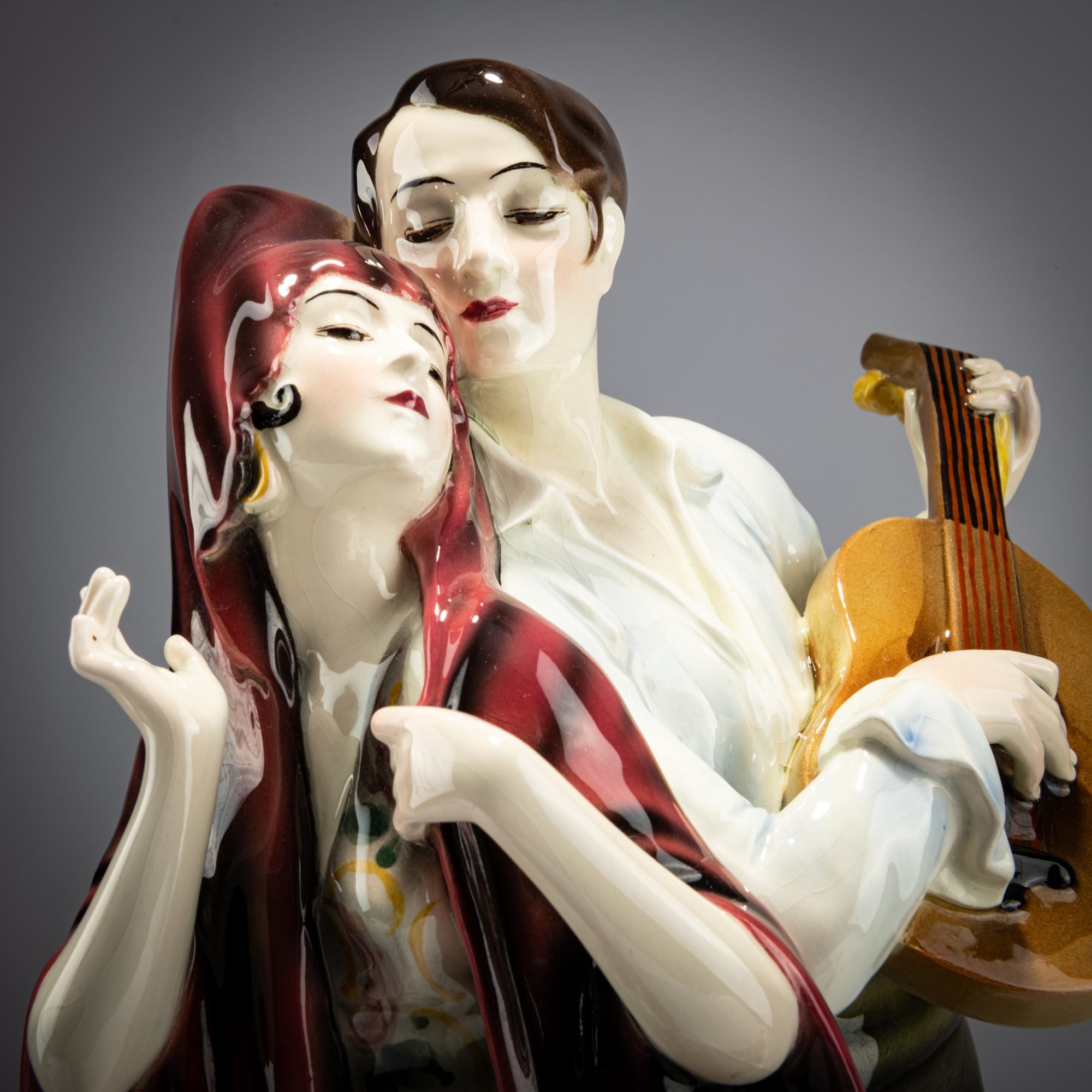 Artwork by Josef Lorenzl, Group of standing dancer in fan-shaped dress, behind her a man with a violin, Made of Earthenware, Polychrome Glaze