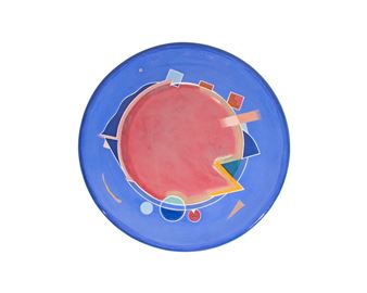 A colorful abstract plate featuring a central red circle surrounded by geometric shapes on a blue background.