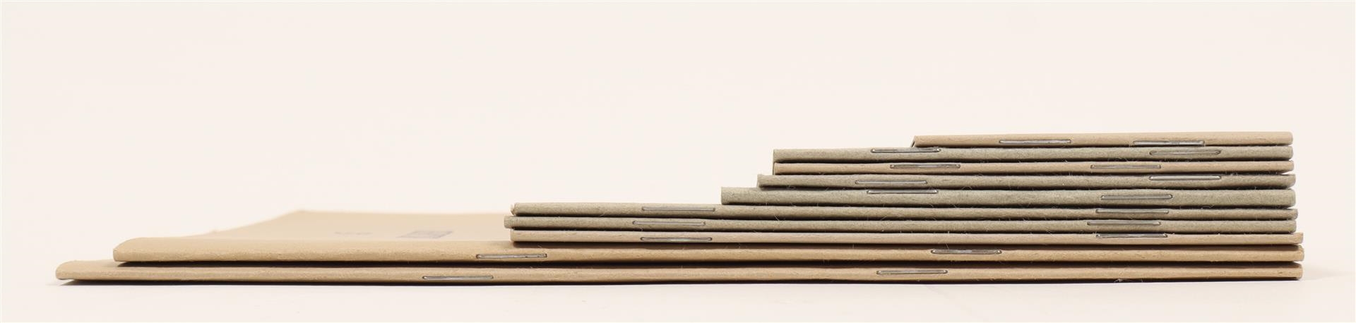 A grid of beige paper cards with printed text arranged in a scattered layout.