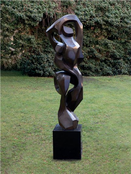 A large metal sculpture sitting on top of a black block.