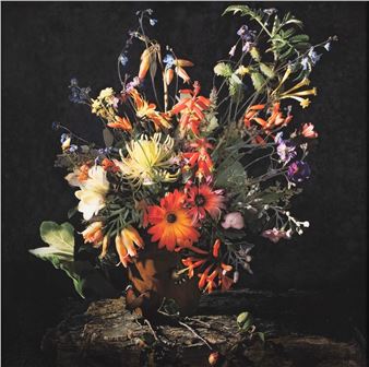 A vibrant floral still life featuring a dense bouquet of wildflowers in a rustic pot.