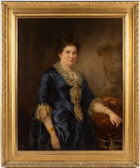 A formal portrait of a seated woman in a dark blue dress with gold trim, framed by an ornate golden border.