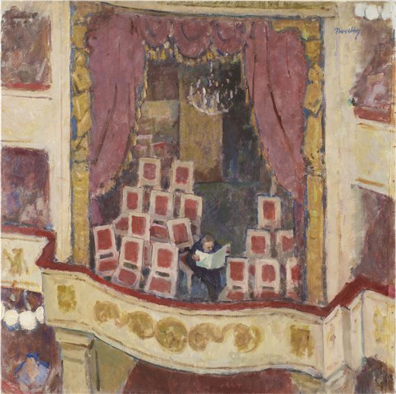 A person reading a book in an ornate theater box filled with empty chairs.