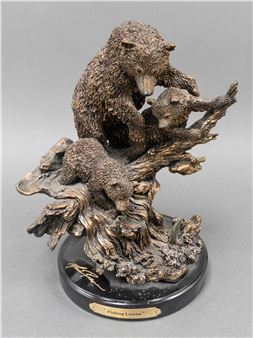 "A bronze sculpture of three bears on a gnarled tree branch, capturing a tender family moment."