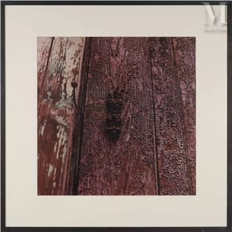 a close up of a wooden door with peeling paint